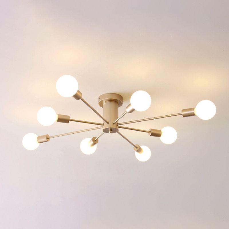 Close view of illuminated gold eight-light ceiling fixture with cylindrical hub and exposed round bulbs