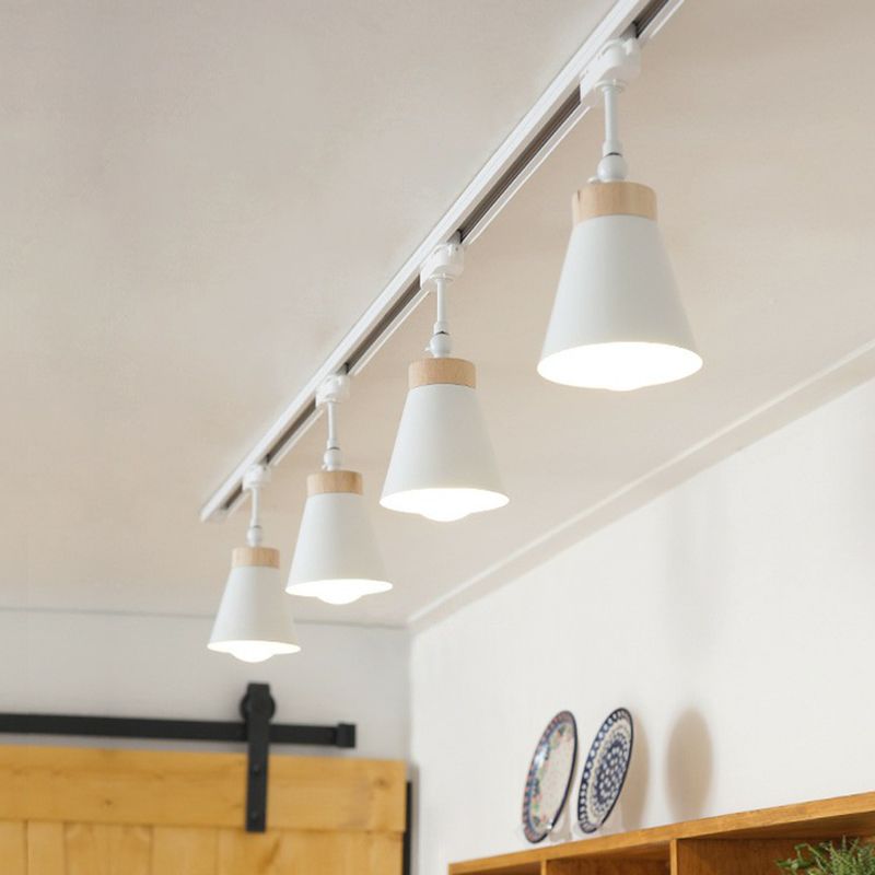 Four white Haney cone spotlights above wood cabinet and decorative plates, with yellow sliding door and black door hardware