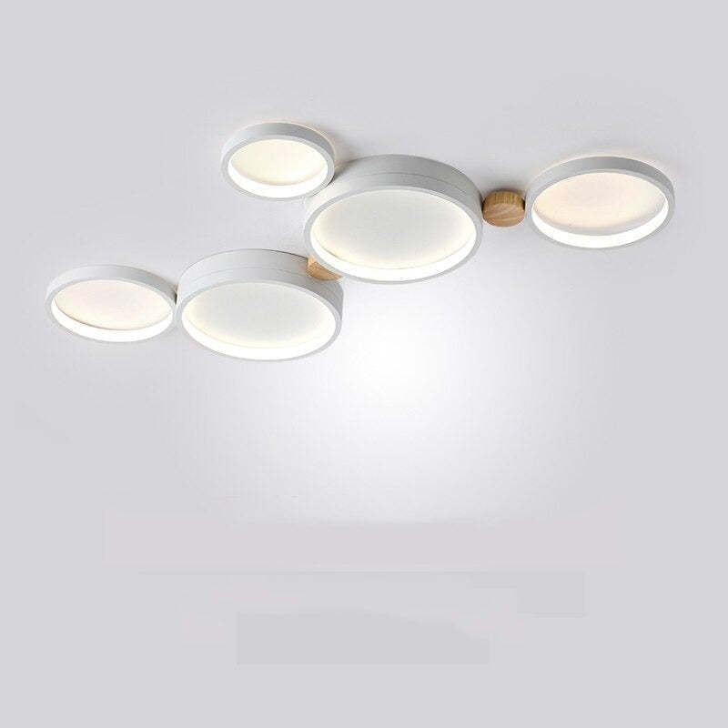 White five-head ceiling light with offset circular panels and wood connectors