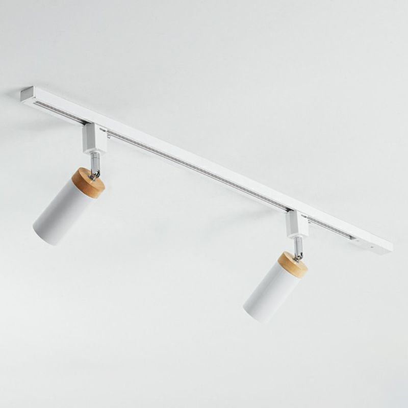 White two-head ceiling rail light with angled tubular spotlights and contrasting tan top collars