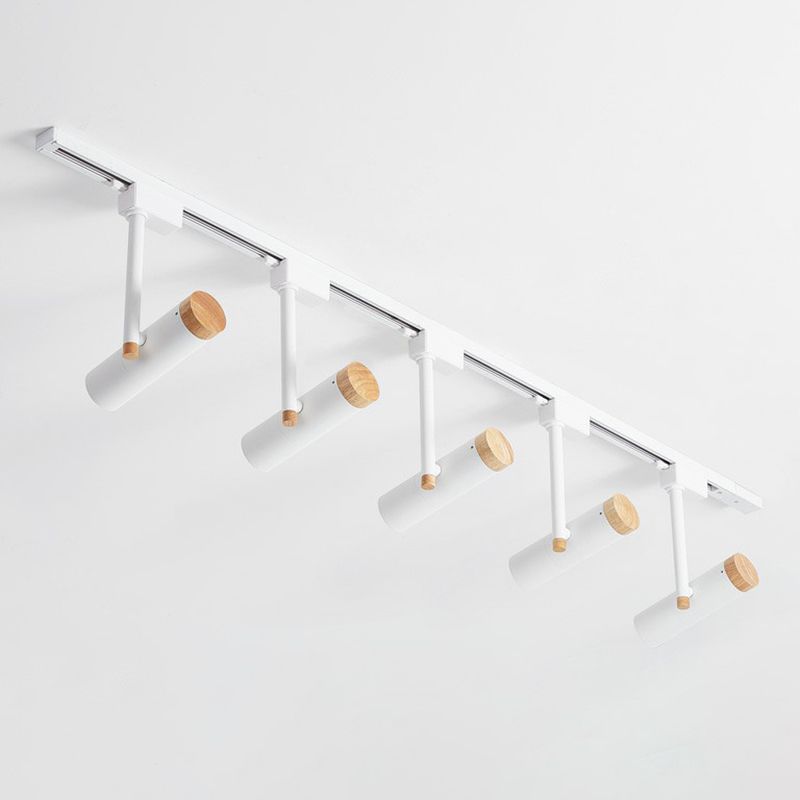 Close white five-head ceiling spotlight rail with wood rear caps and slim stems