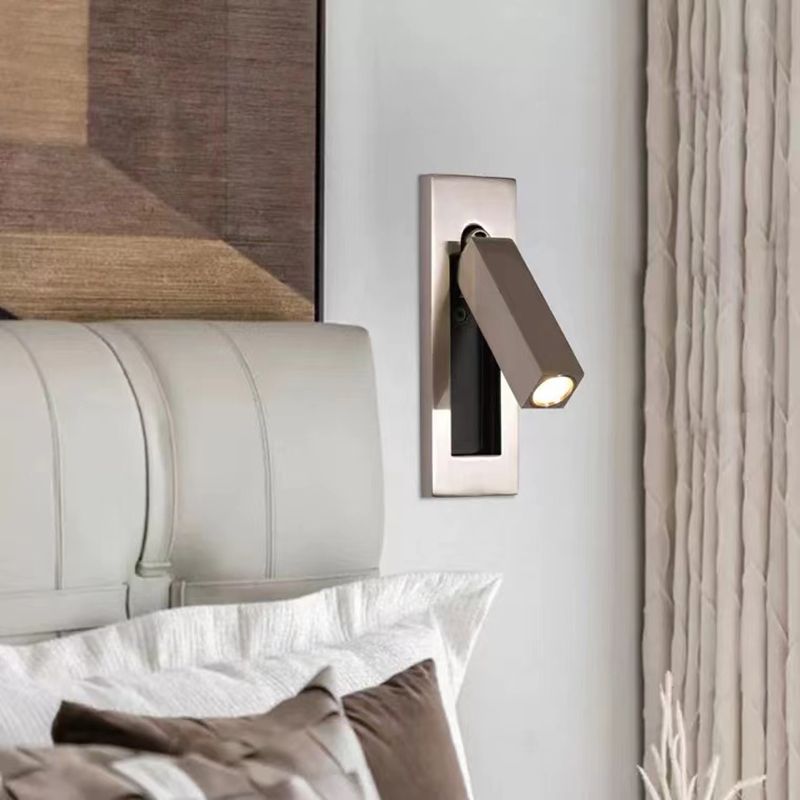Orr rectangular spotlight on a reflective wall plate beside a headboard and curtains