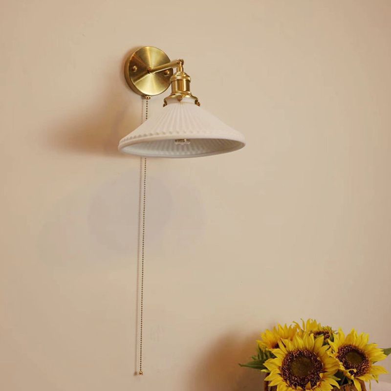 Unlit Lottie broad white pleated cone shade showing its underside on gold-tone wall fittings