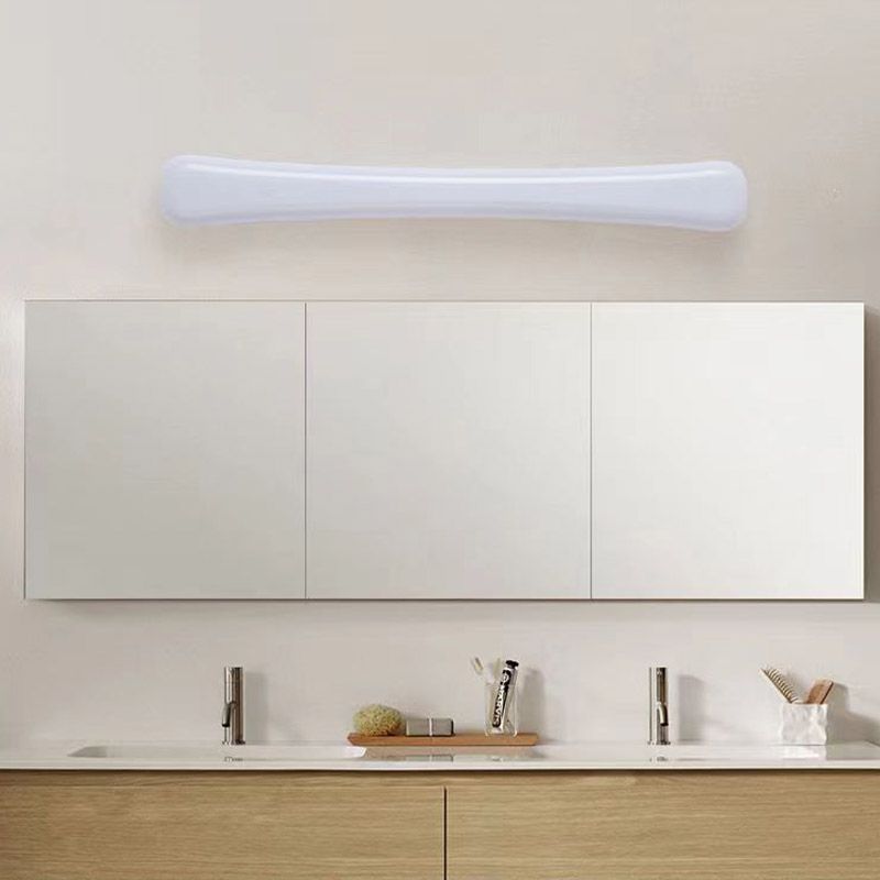 Unlit-looking white Edge bar above four-panel mirror cabinet and double-basin wood vanity with two faucets