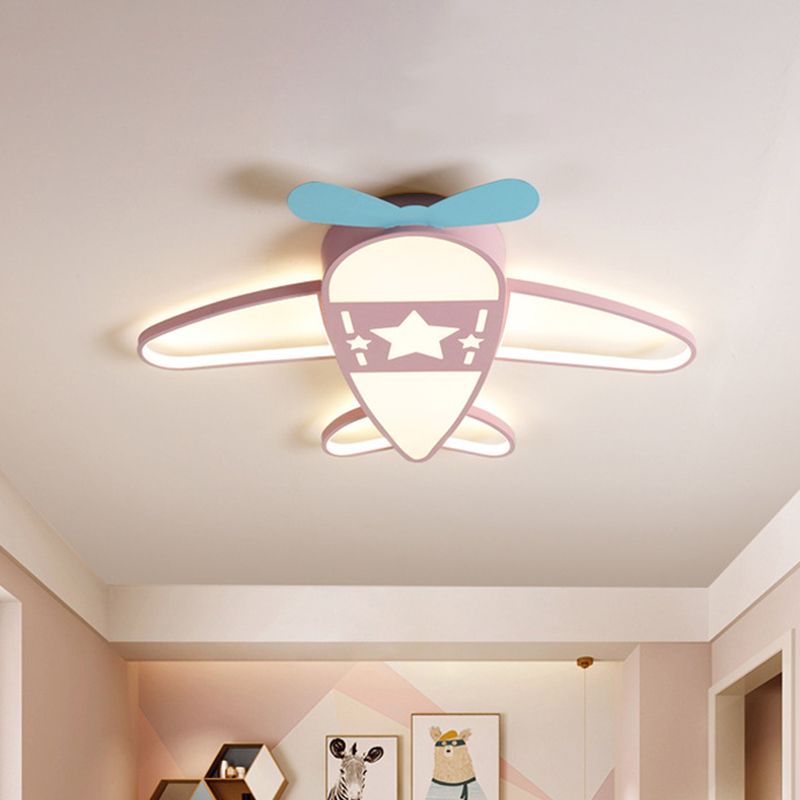 Pink Morandi airplane ceiling light with a blue propeller and star detail above a bedroom.