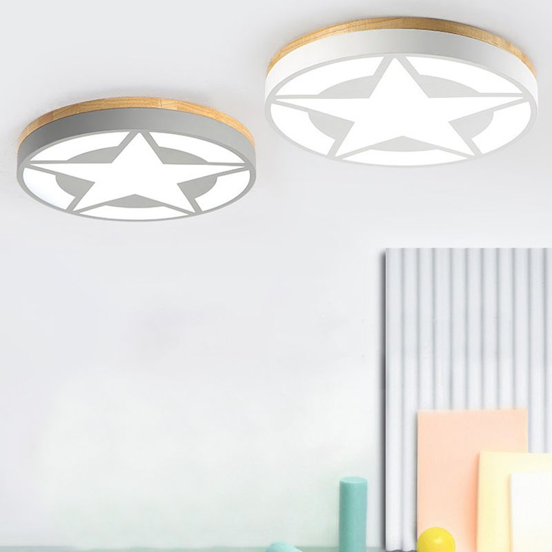 Grey and white round star-pattern ceiling lights side by side above pastel room ornaments