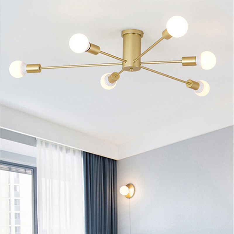 Gold six-light radial-arm ceiling fixture beside a curtained window and separate wall lamp