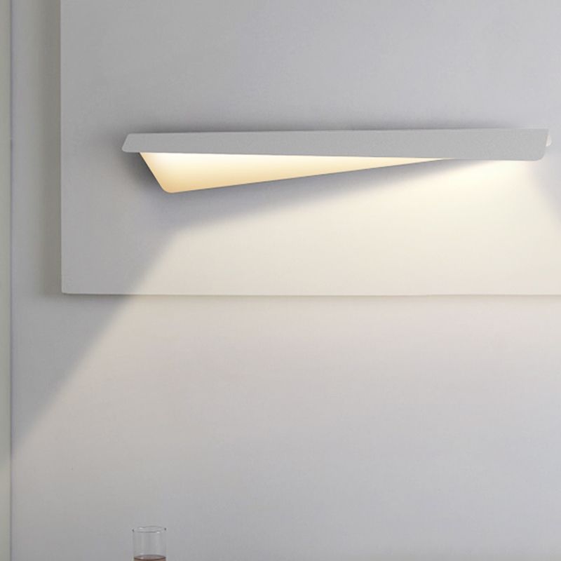 Leigh white tapered panel wall light above a pale wall panel with a glass partly visible below