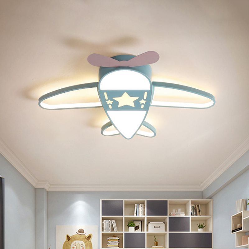 Blue Morandi airplane-shaped ceiling light illuminated above a bedroom.