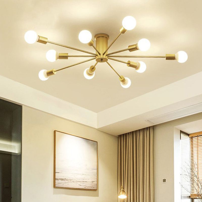 Gold ten-light ceiling fixture glowing above framed landscape art and a curtained window