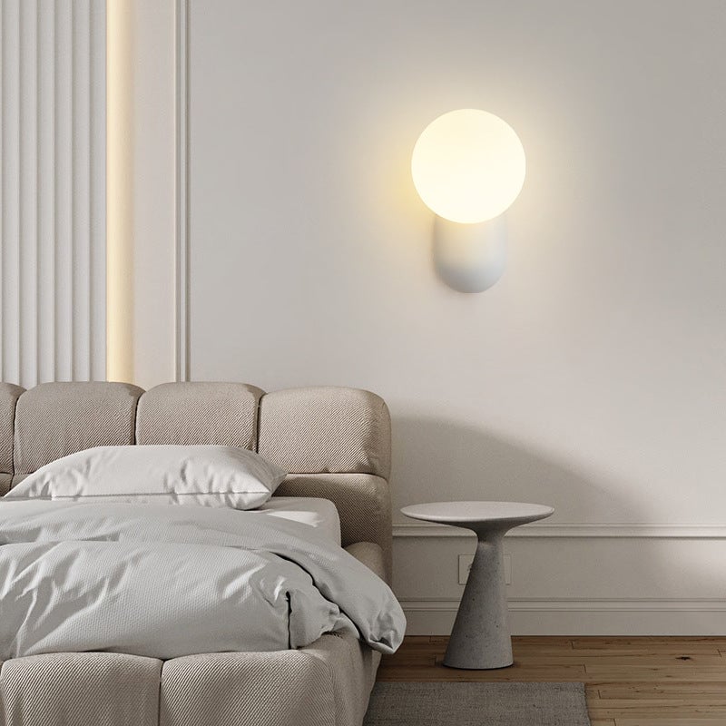 White Hailie globe wall light in a neutral bedroom