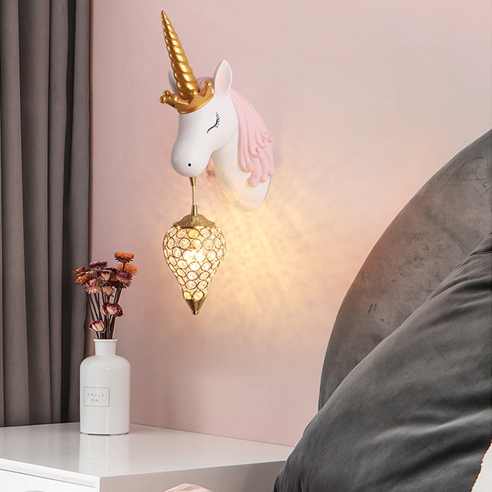 Pink-maned unicorn with gold-tone horn and pointed hanging shade above a bedside unit