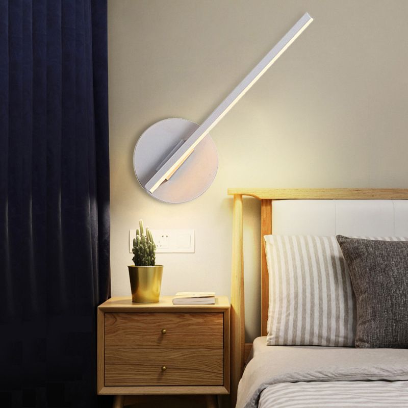 White Edge bar angled above a bedside table on a round base