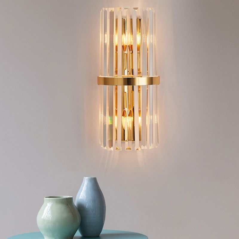Kristy D straight clear prisms with a central gold-tone band above a table with ceramic vases