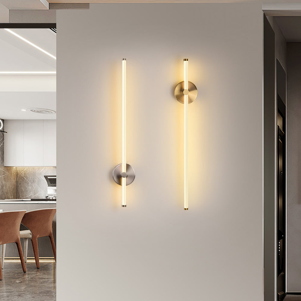 Silver-tone and gold-tone Edge rod wall lights beside a dining opening, with different rod positions