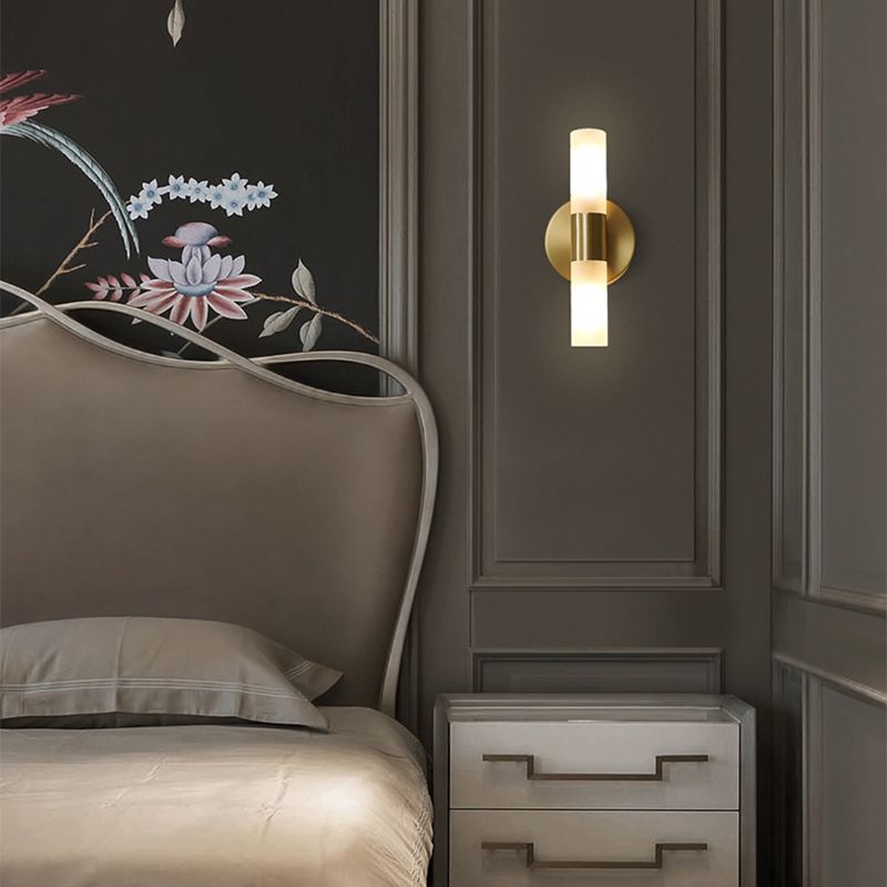 Leigh double-ended vertical wall lamp beside a bed