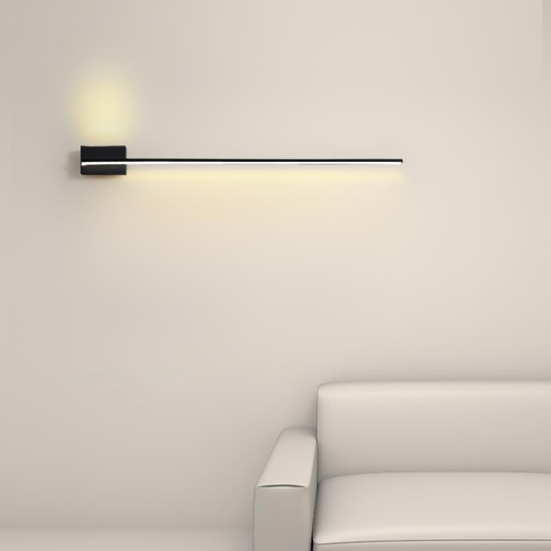 Warm White black linear wall light above a white sofa, with warm-looking lower and upper light