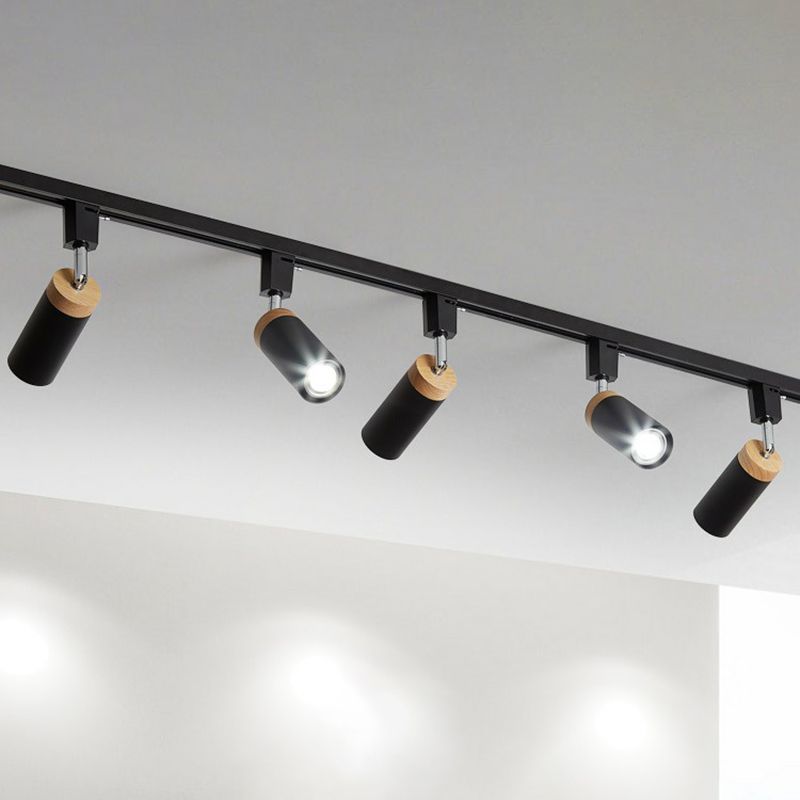 Black five-head rail light with spotlights aimed at different angles and two bright openings facing forward