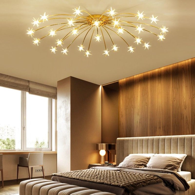 Gold-tone star ceiling lamp above padded bed, timber accent wall and desk by window with separate bedside lamp