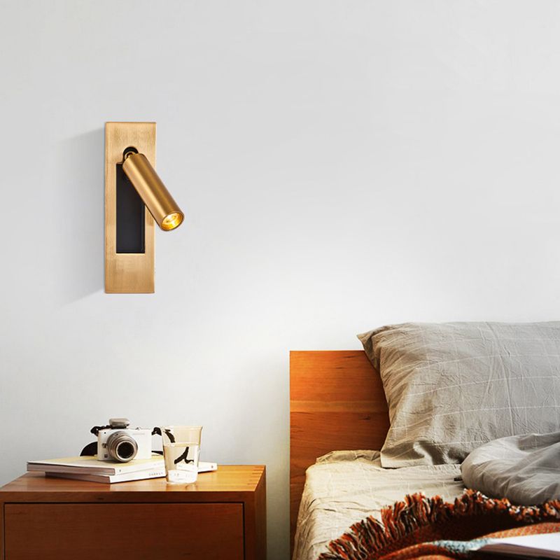 Orr gold-colour bedside spotlight above a small table