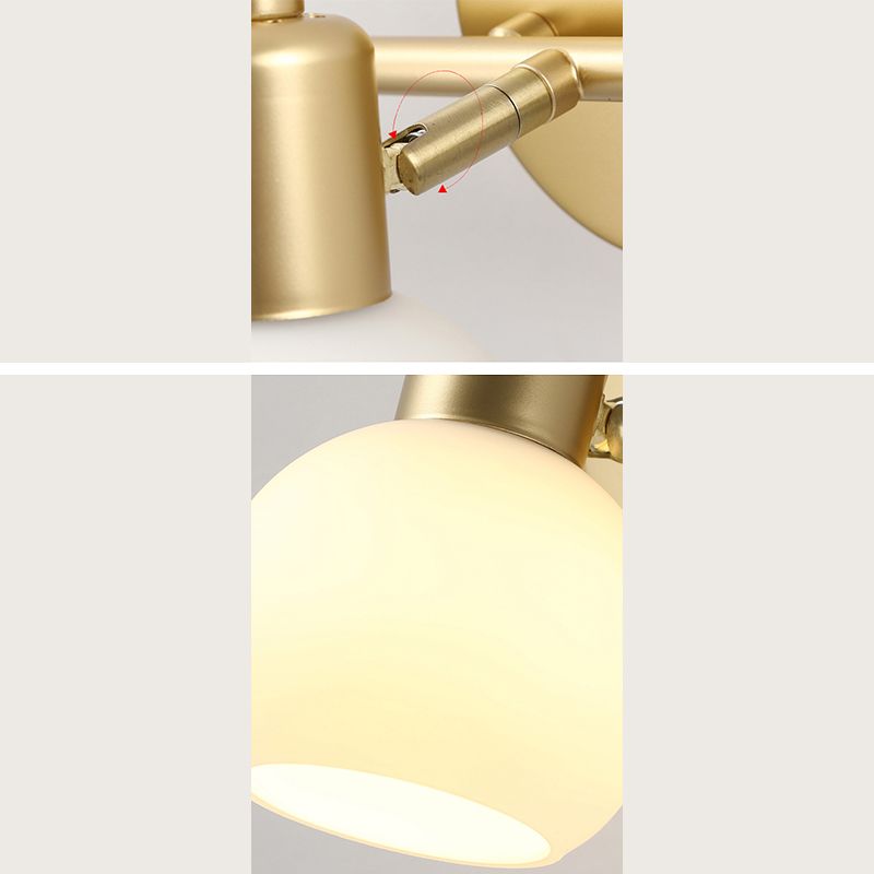 Composite detail showing a curved adjustment arrow at the Gold head-arm hinge and a close-up of a lit globe shade