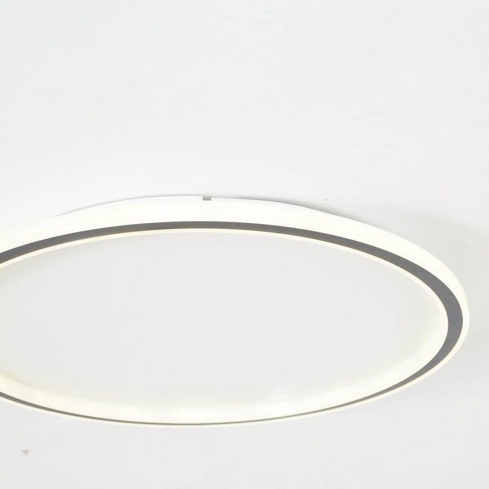 Close view of a glowing White rim and Black inner band, with a raised mounting section above the ceiling ring