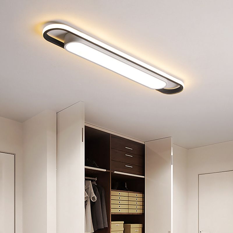 Lit rounded linear ceiling fixture above an open wardrobe and doorway