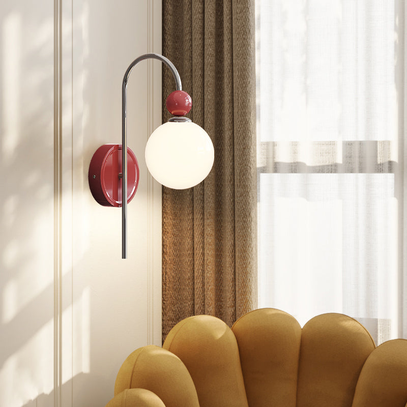 Red Model B wall light beside a window and chair