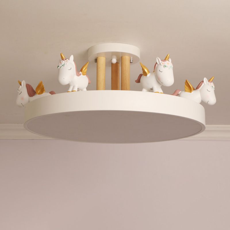 White unicorn ceiling light close under the ceiling, showing wood-tone posts and an unlit underside