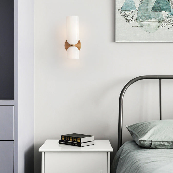 White Hailie wall light beside a bed