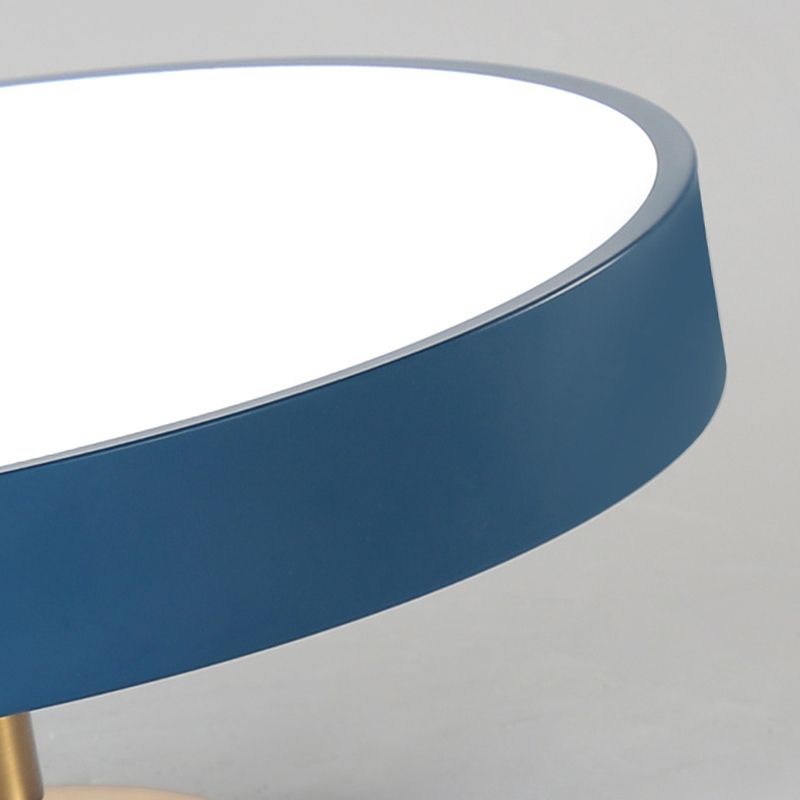 Close curved blue rim and white diffuser edge of the circular ceiling fixture