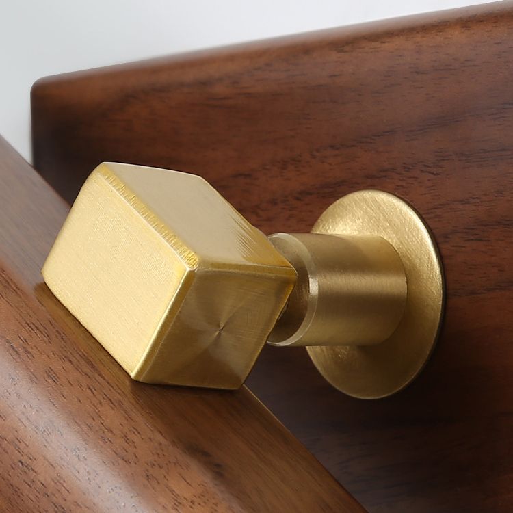 Close-up of Ozawa gold-tone central pivot block and circular attachment on the wood backplate