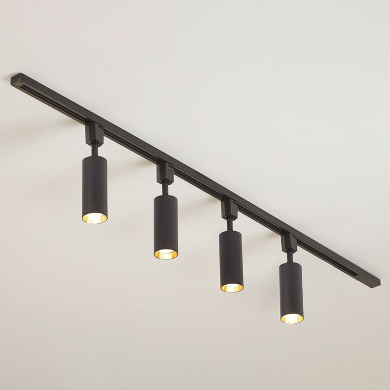 Large black four-head ceiling spotlight with longer cylinders on a black rail
