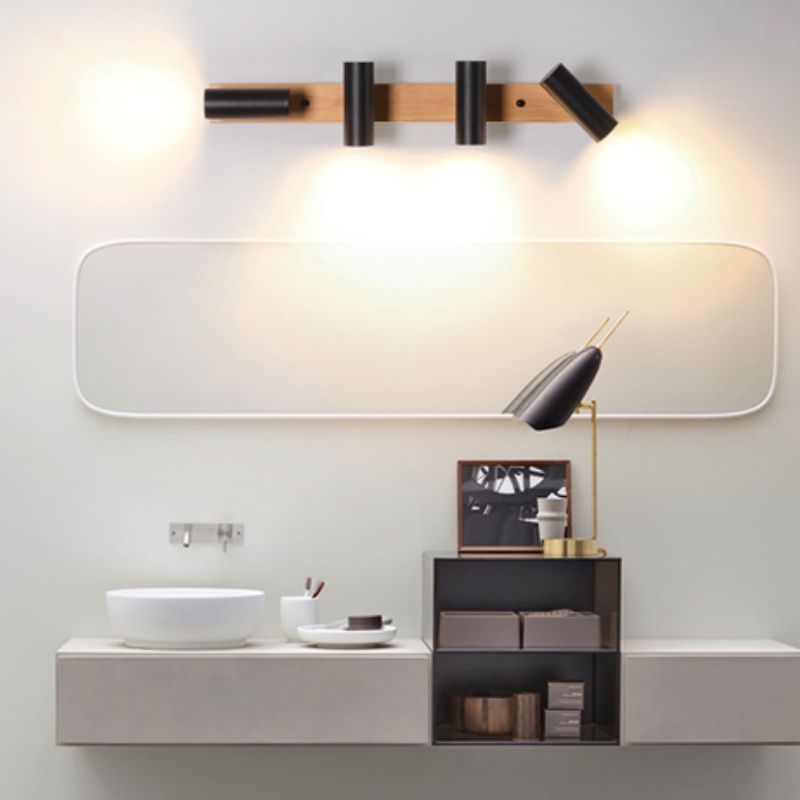 Four black Ozawa spots on a wooden bar above a rounded mirror, with outer heads aimed differently