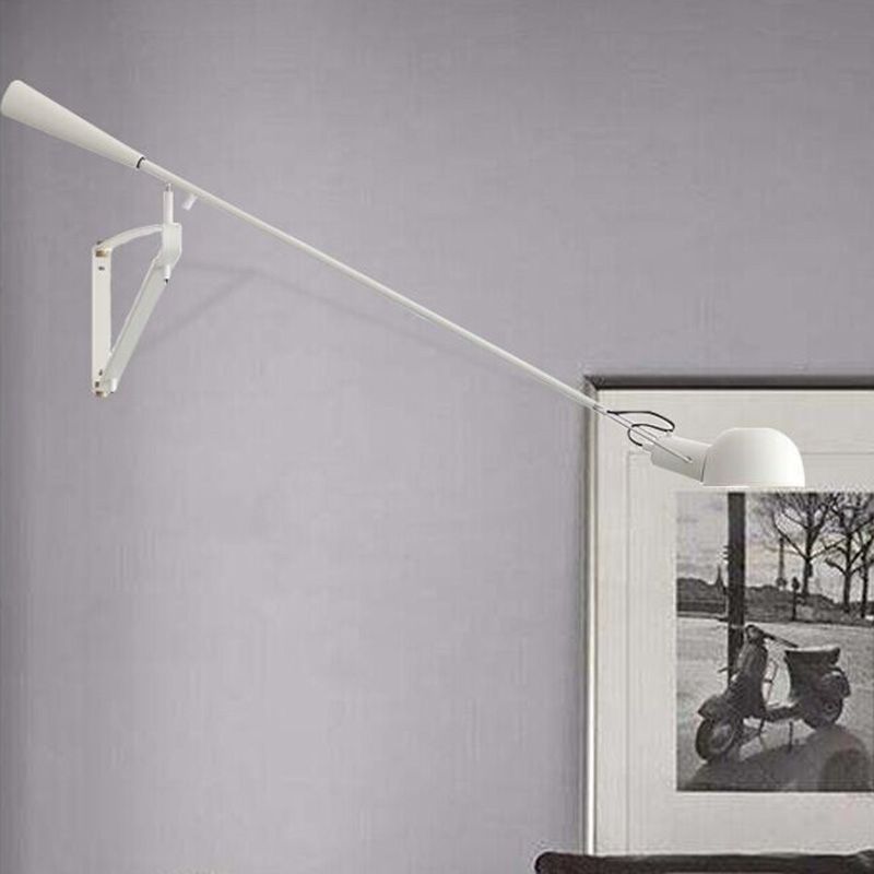 White Brady dome head and long arm near wall artwork