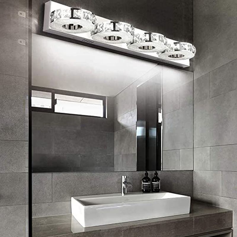 Kristy four round heads above a wide bathroom mirror