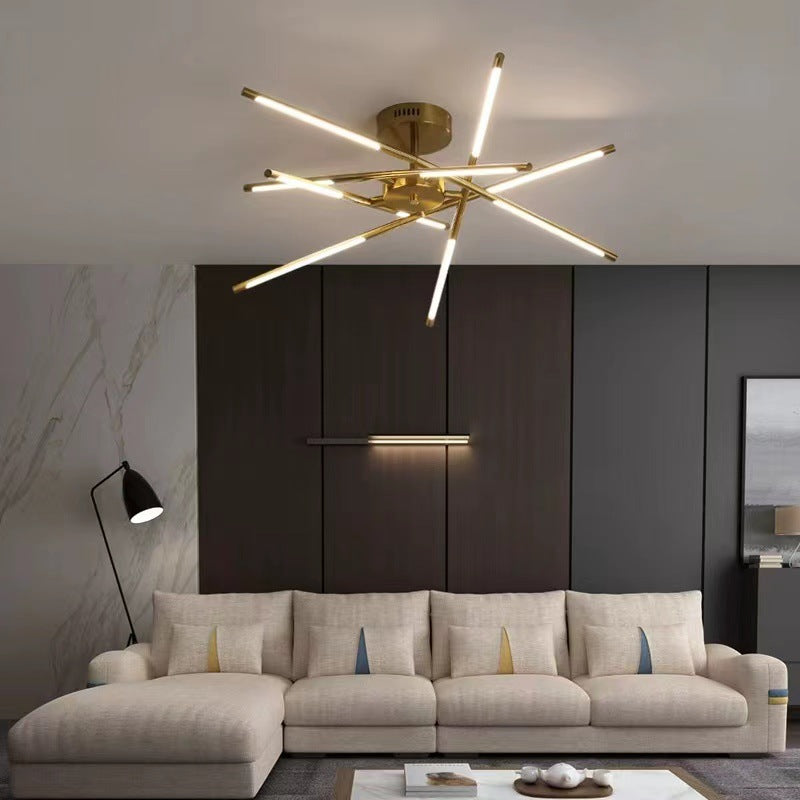 Gold Edge ceiling light with luminous crossing bars above a living-room sofa