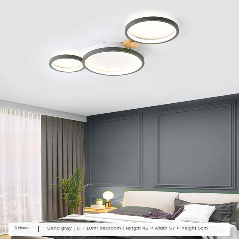 Gray three-head ceiling light in a bedroom, with a caption showing 42 by 57 by 5 cm
