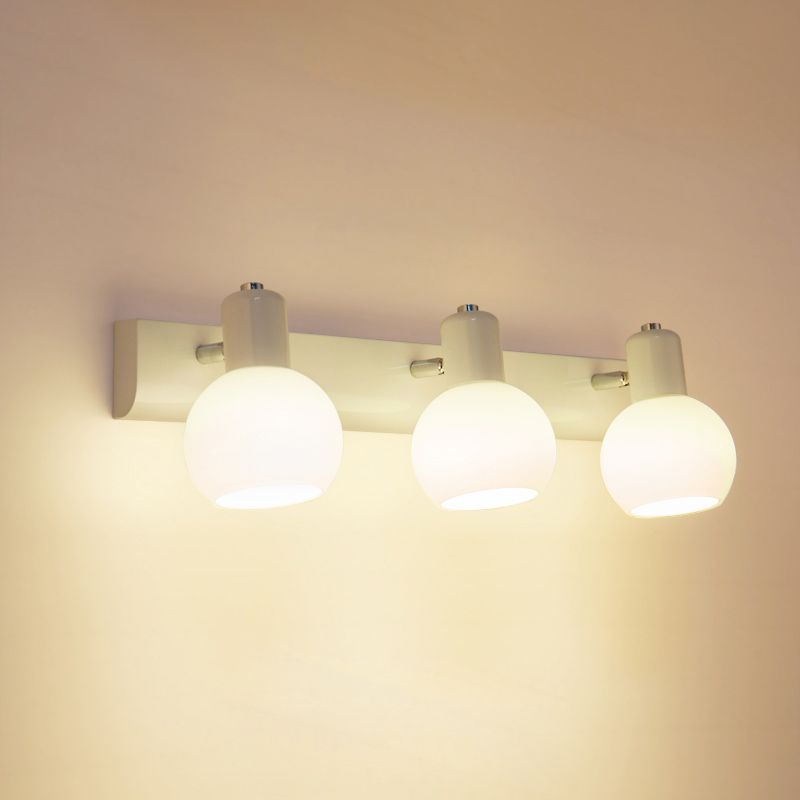 White Valentina three-globe wall light on a long rectangular mounting base