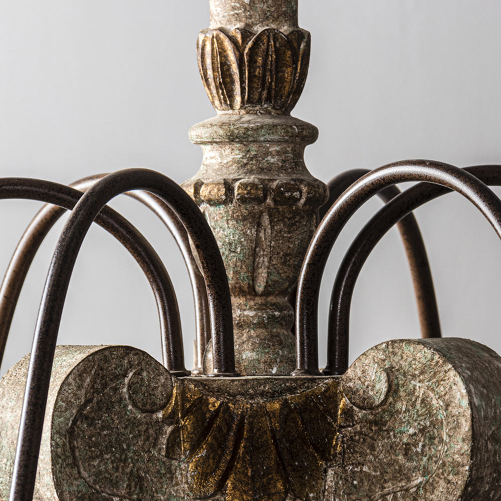 Silva looping dark arms around an ornate bronze-tone and grey-green central column
