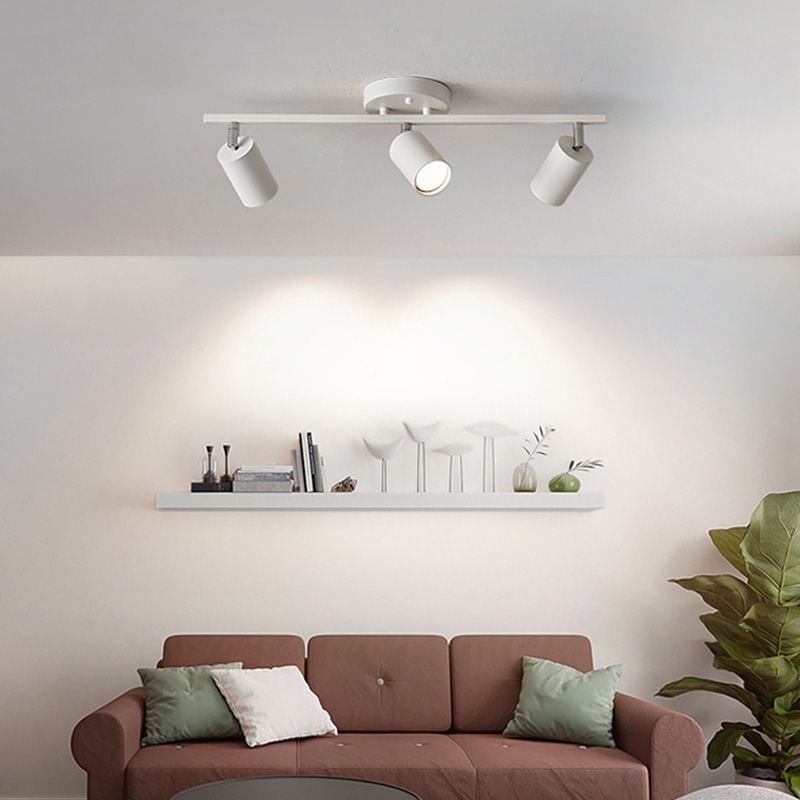 White Freja three-head spotlight above a pink sofa