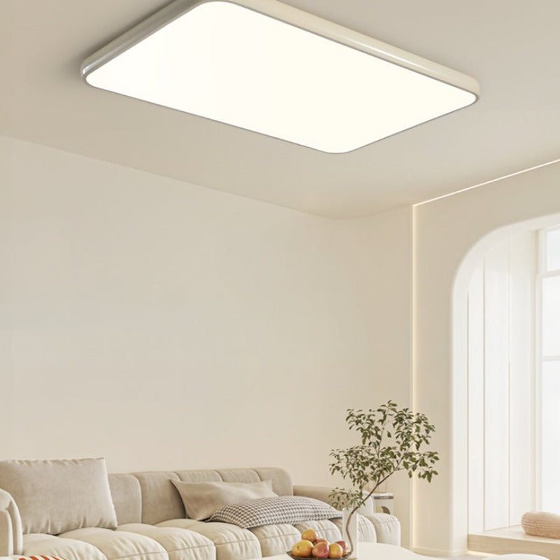 Cream-yellow rectangular Valentina ceiling light above a sofa