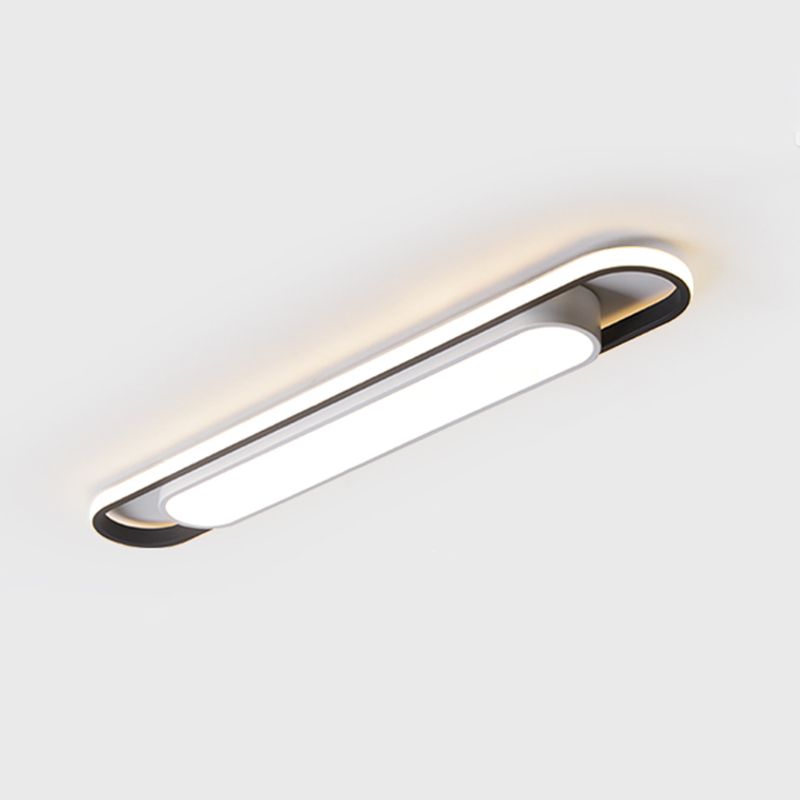Lit rounded linear ceiling fixture with bright central panel against a pale ceiling