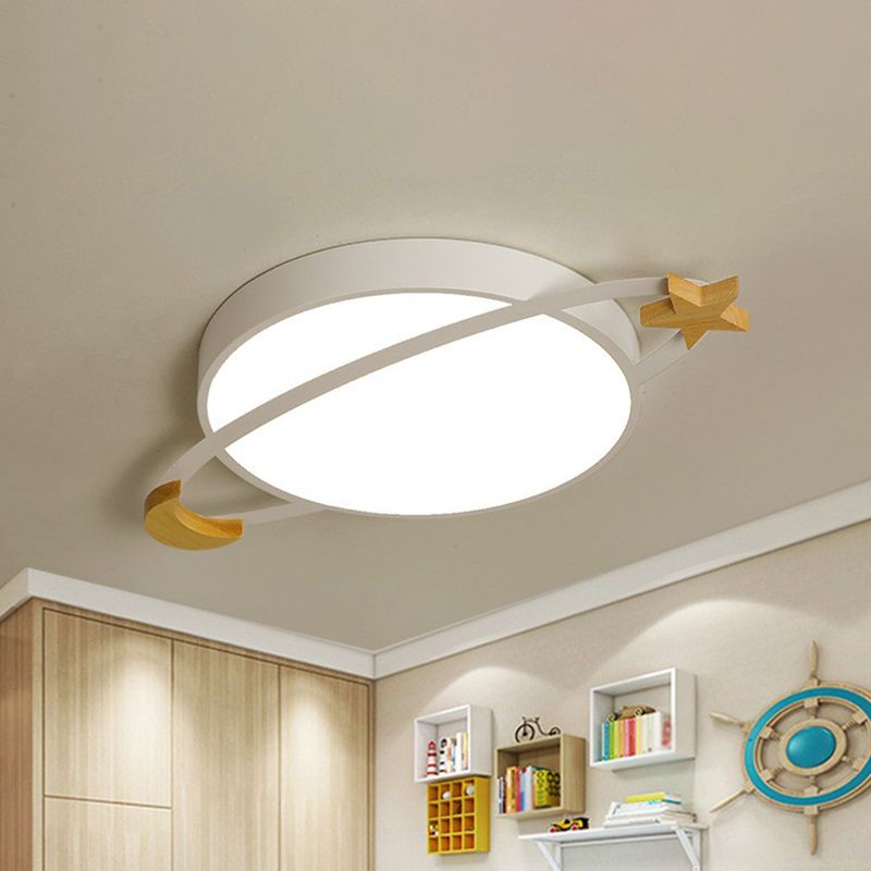 White Morandi planet ceiling light illuminated in a bedroom.