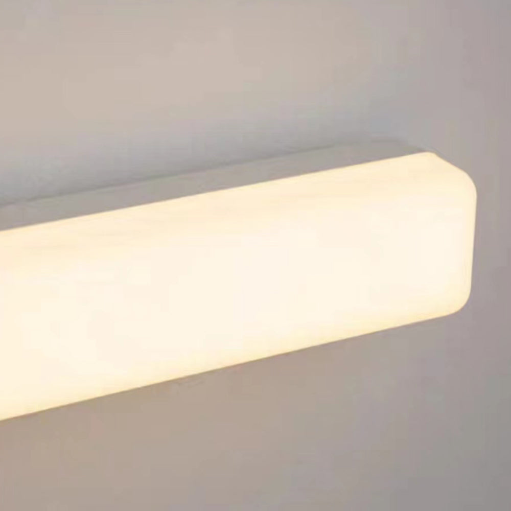 Warm illuminated rounded end of the Edge white mirror light
