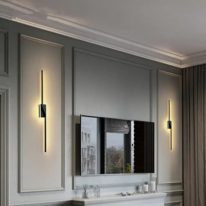 Two slim dark Nordic wall lights placed beside a mirror