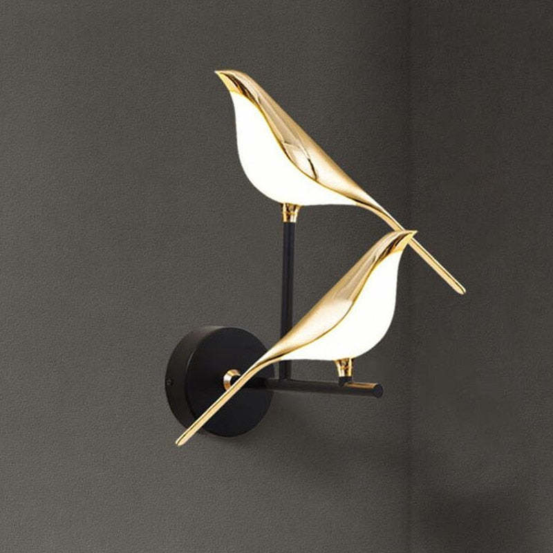 Two lit bird bodies on a tall Black support