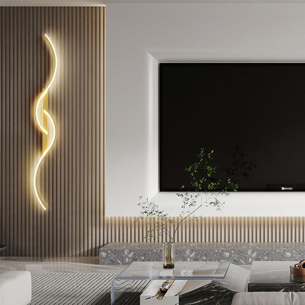 Gold vertical wave wall light beside a television, wood slats and a glass coffee table
