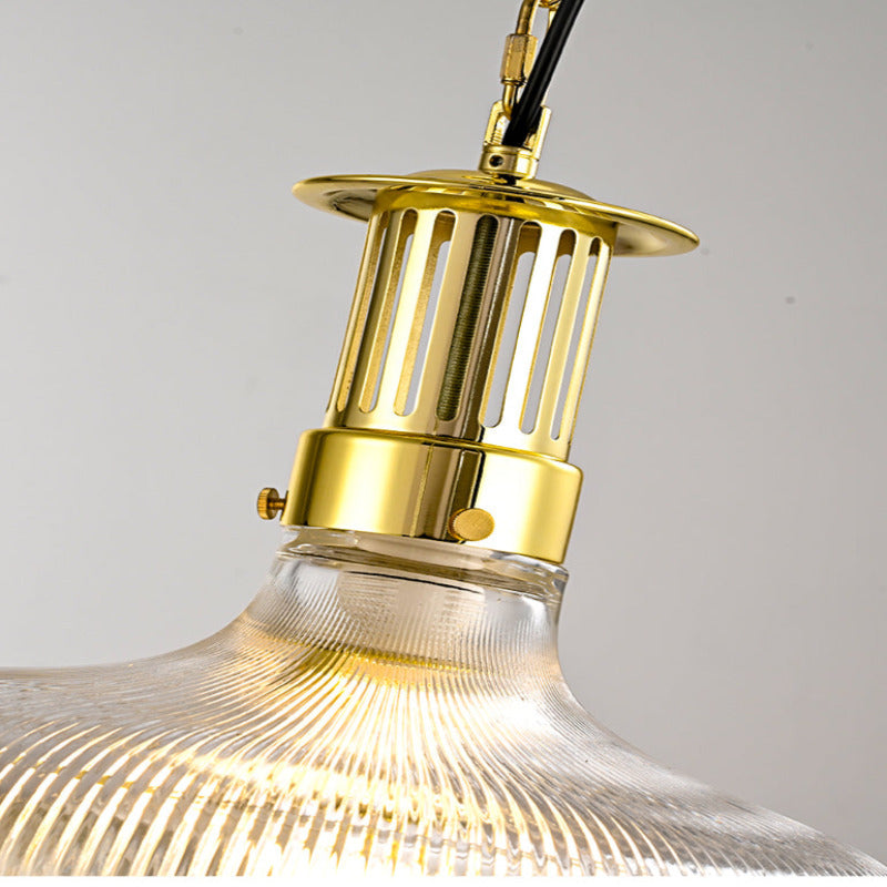 Close view of the Alessio gold-toned upper cage and ribbed glass shoulder.