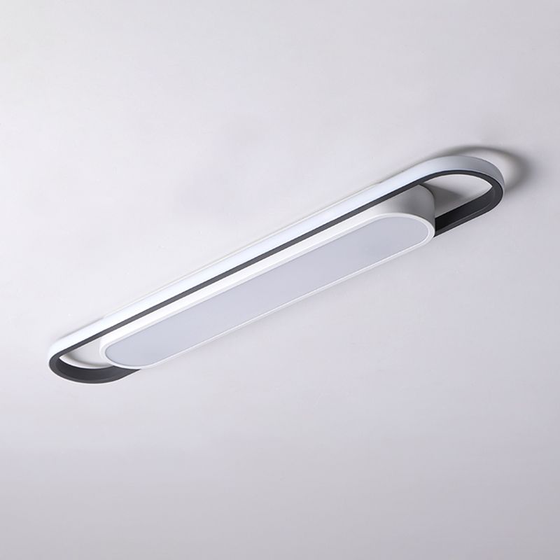 Unlit linear ceiling fixture with pale outer frame, dark inner edge and shorter frosted panel